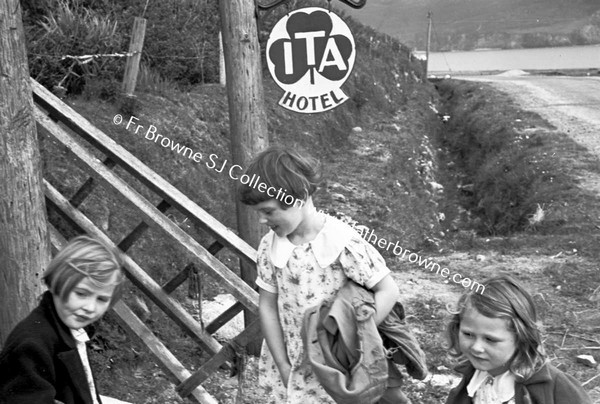 CHILDREN WAITING IN GROUP AT SIDE OF ROAD